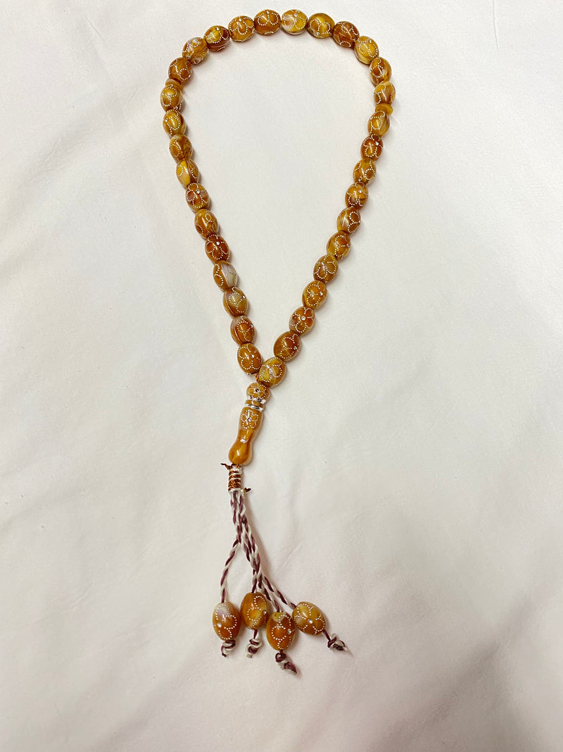 Brown prayer beads with design